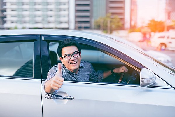 good looking Asian man is smiling and raising his thumb